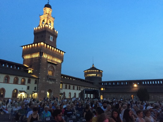 Audience at early evening perfomance in the courtyard of Castello Sforzesco, Milan