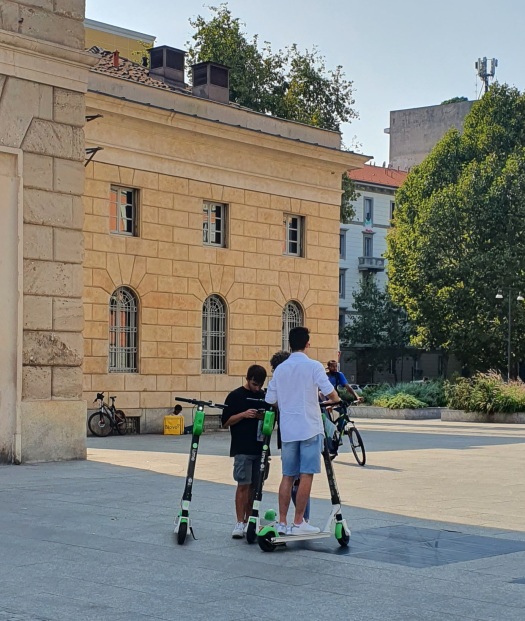 Kids with e-scooters on Piazza Venticinque Aprile, Brera, Milan