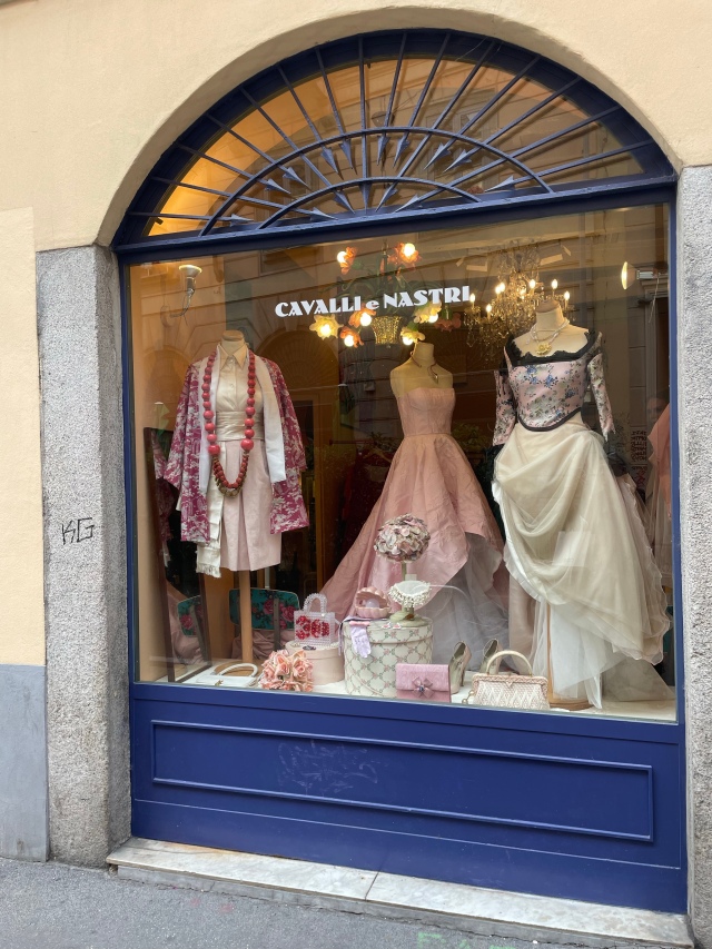 Vintage evening dresses in thrift store Cavalli e Nastri shop window